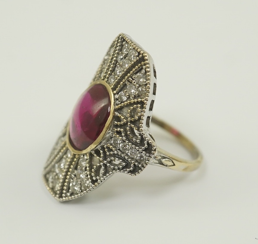 A gold, cabochon ruby and diamond cluster set upfinger ring